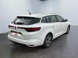 the rear view of a white car in a showroom