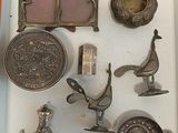 a white box with a bunch of silver objects in it