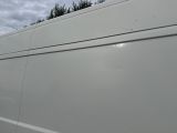 a white van that is parked on the side of the road