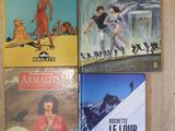 four books on a wooden table with a picture of a man on a snowboard