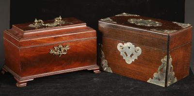 pair of antique wooden boxes with brass hardware on black background