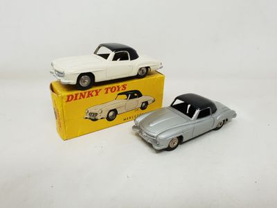 two toy cars are sitting on top of a yellow box