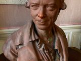 a bust of a man sitting on a table in a room