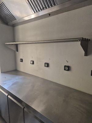 a kitchen with stainless steel counter tops and cabinets