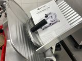 a meat slicer sitting on a counter in a kitchen