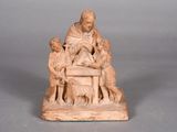 an old statue of a man sitting on top of a table surrounded by children
