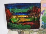 a painting of a landscape on a table next to some rocks