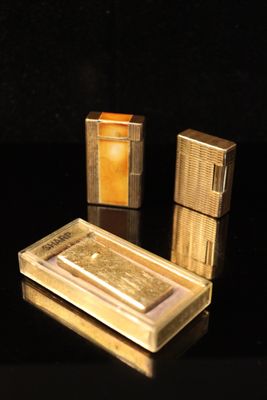 three lighters that are sitting on a table