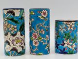 three vases sitting next to each other on a table