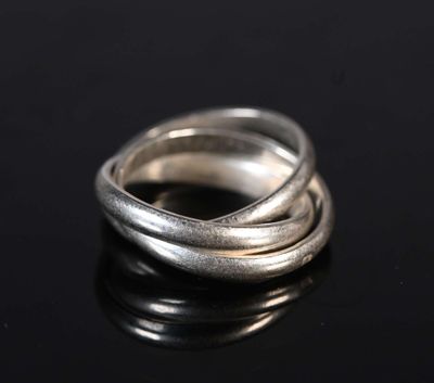 a close up of a silver ring on a black surface