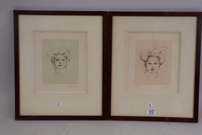 two framed drawings of a woman ' s face and a man ' s head