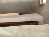 two beds in a small room with no sheets on them