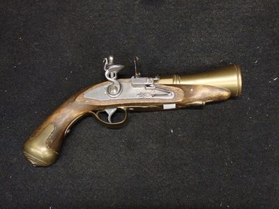 an old gun that is on display on a black surface