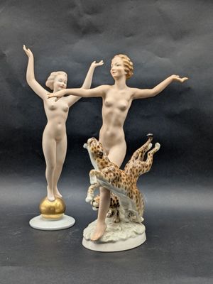 two figurines that are standing next to each other
