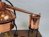 a copper pot and a copper kettle on a wooden stand