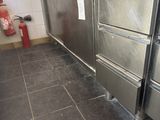 a large stainless steel oven in the middle of a kitchen