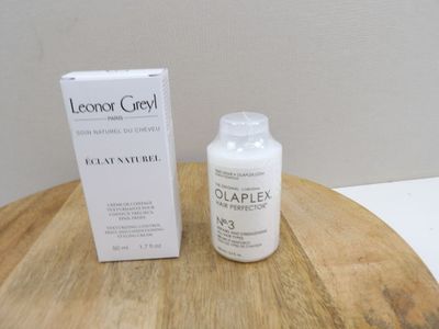 a bottle of liquid sitting on a table next to a box
