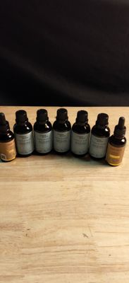 several bottles of essential oils sitting on a wooden table