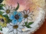 a picture of a broochee with flowers painted on it