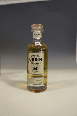 a bottle of alcohol sitting on a counter next to a bottle of liquor