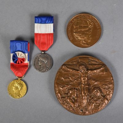 three medals and a medal on a table with a gray background