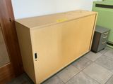 a large wooden cabinet in the corner of a room next to a green cabinet