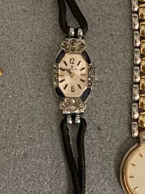two watches are sitting next to each other on a table