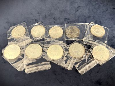 several gold coins in clear plastic bags on a black surface