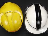 two hard hats sitting next to each other on a table