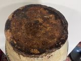 a blue plate with a brown object on top of it