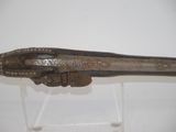 a very old gun that is on display in a museum