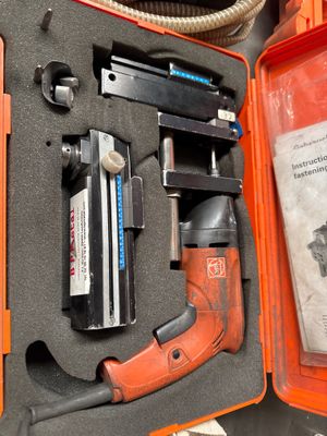 an orange case with tools in it on a table