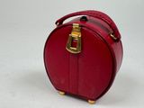 a small red suitcase sitting on a white surface