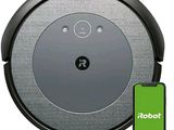 un gros plan d'un aspirateur robot muni d'un bouton vert