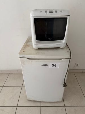 a microwave sitting on top of a refrigerator in a room