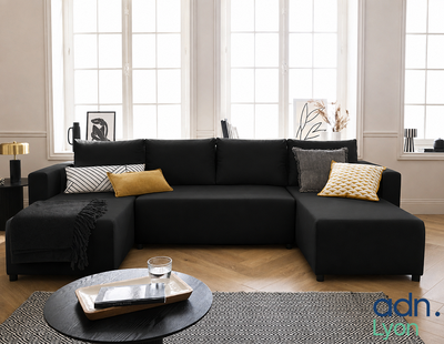 a black couch with yellow pillows in a living room
