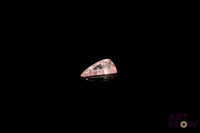 a close up of a pink diamond on a black background