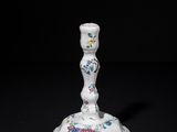a white candle holder with a floral design on it