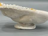 a white bowl with a yellow flower inside of it