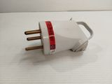a white electrical plug with a red stripe on it