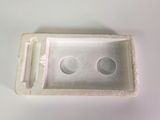 a white box with two holes in it on a table