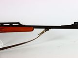 a close up of a rifle on a white surface with a white background
