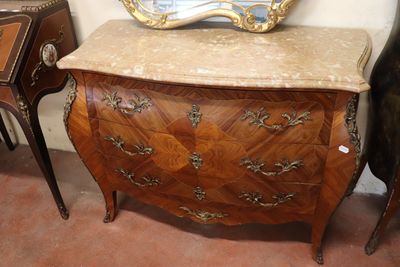 a marble top chest of drawers with a mirror on top of it
