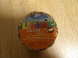 a container of carrot flavored yogurt sitting on a table