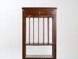 an antique wooden book shelf with a glass shelf on top