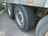 a truck with a flat tire parked on the side of the road