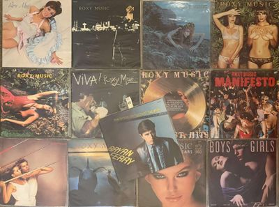 many different album covers on the wall of a room