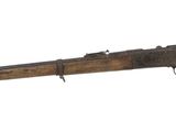 an old rifle with a wooden barrel on a white background