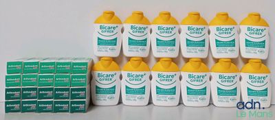 several bottles of biocanrex sit on a table next to a stack of boxes