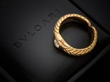 a close up of a gold ring with a diamond on it